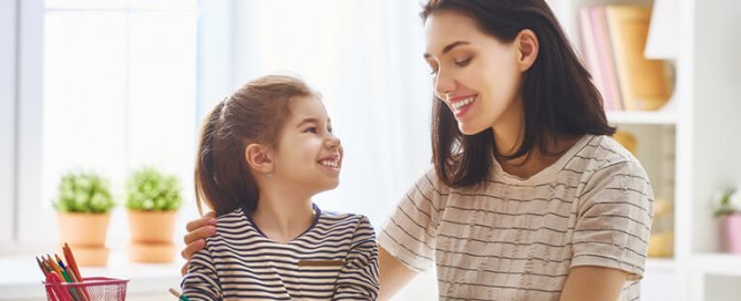Mother helping her daughter with mathematics