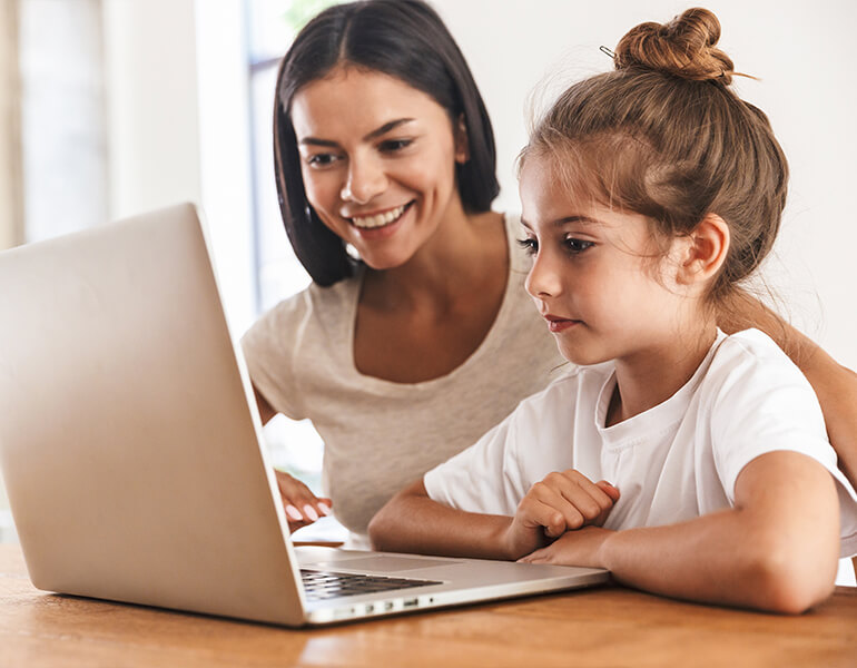 mother and daughter using a laptop
