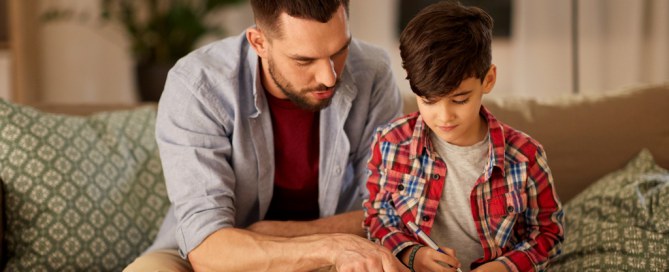 father helping his son with home learning