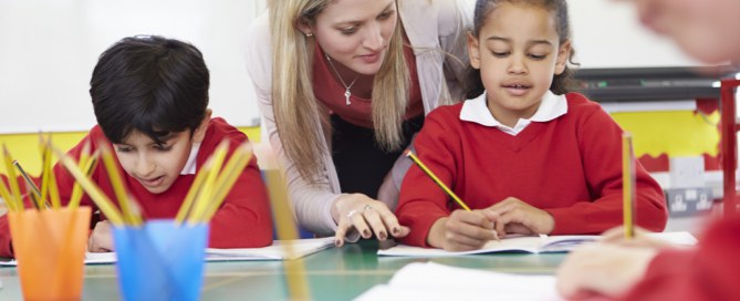 teacher helping young girl with formative assessment