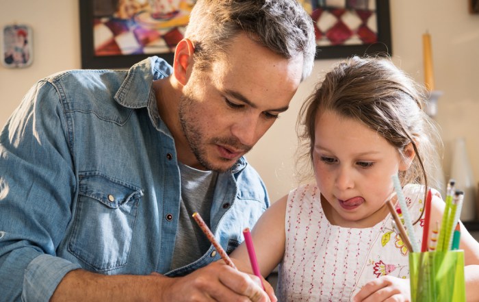 father helps daughter with her homework
